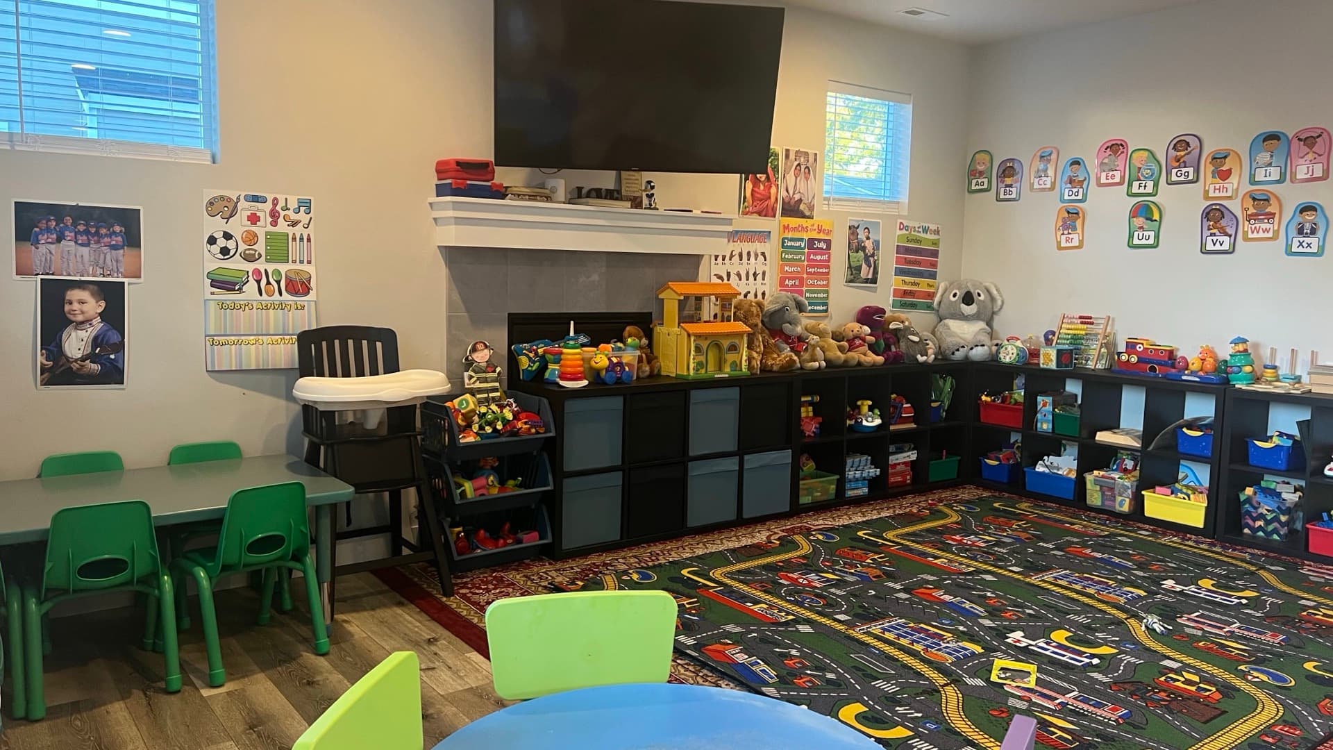 The Sunny Daycare playroom — child-height tables, alphabet wall, and organized toy storage in a real home